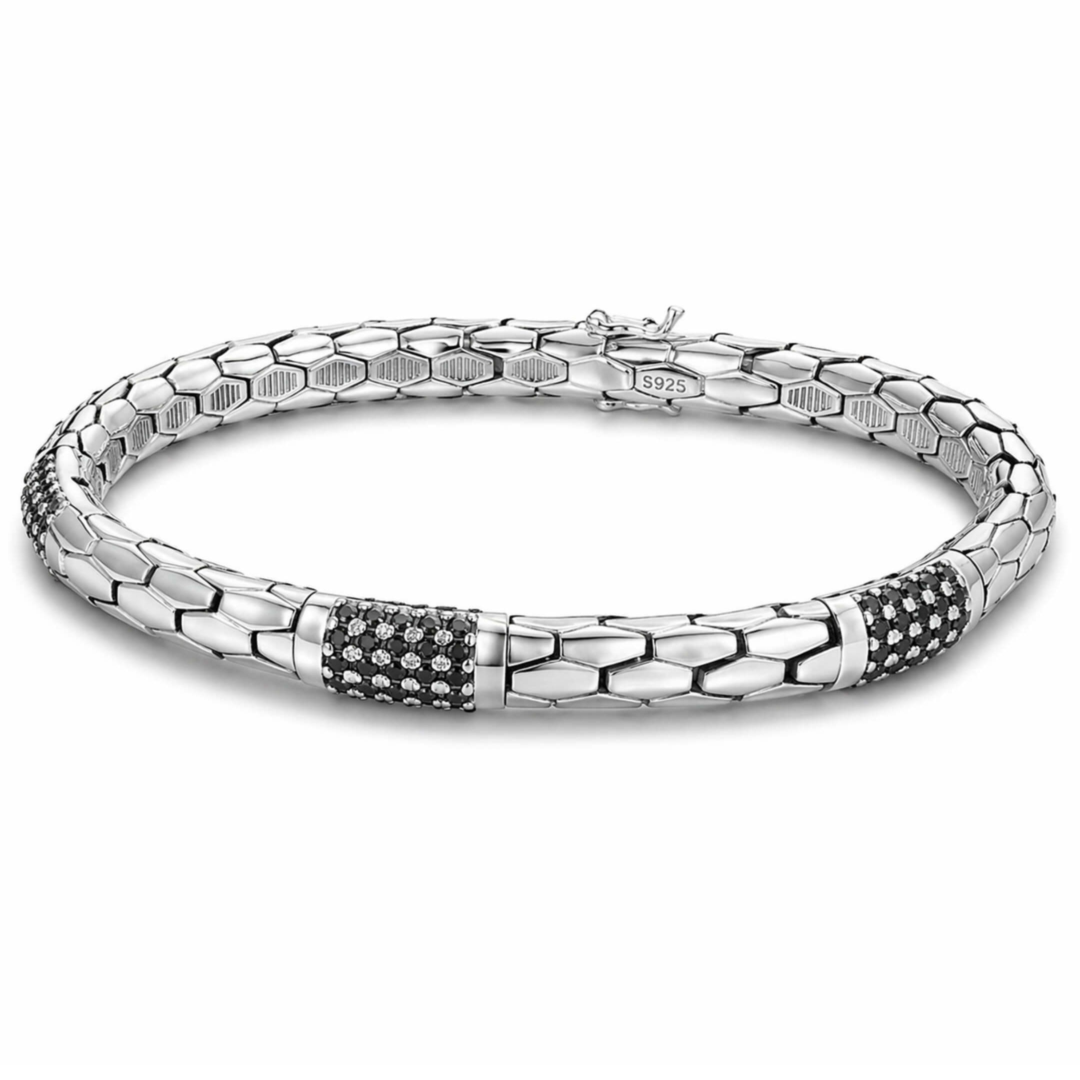Silver bracelet with black accents on a white background