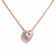 Rose gold heart-shaped necklace with a clear gemstone on a white background