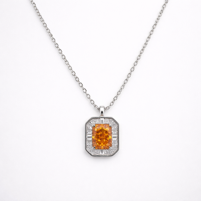 Diamond necklace with a central orange gemstone on a white background