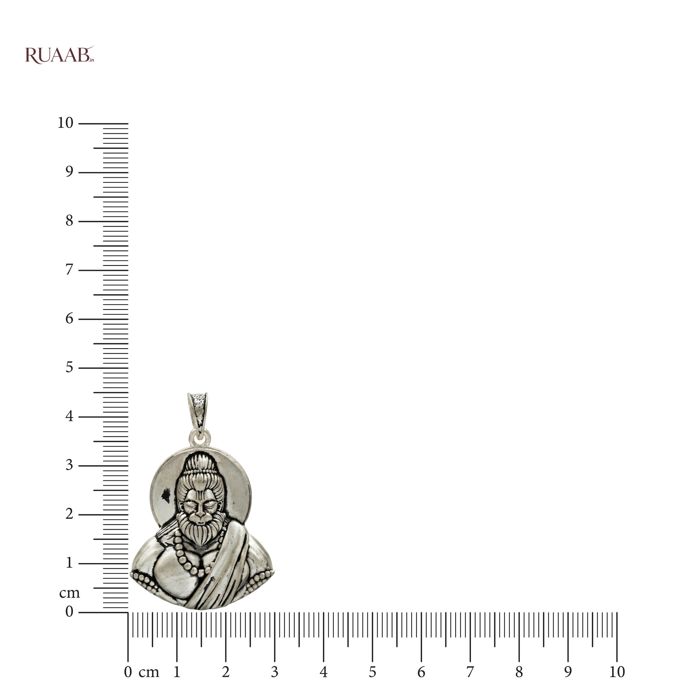 Silver pendant of a bearded figure with a ruler for scale on a white background