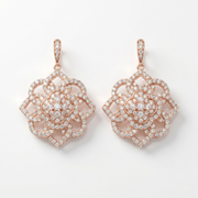 Rose gold earrings with diamond accents on a white background