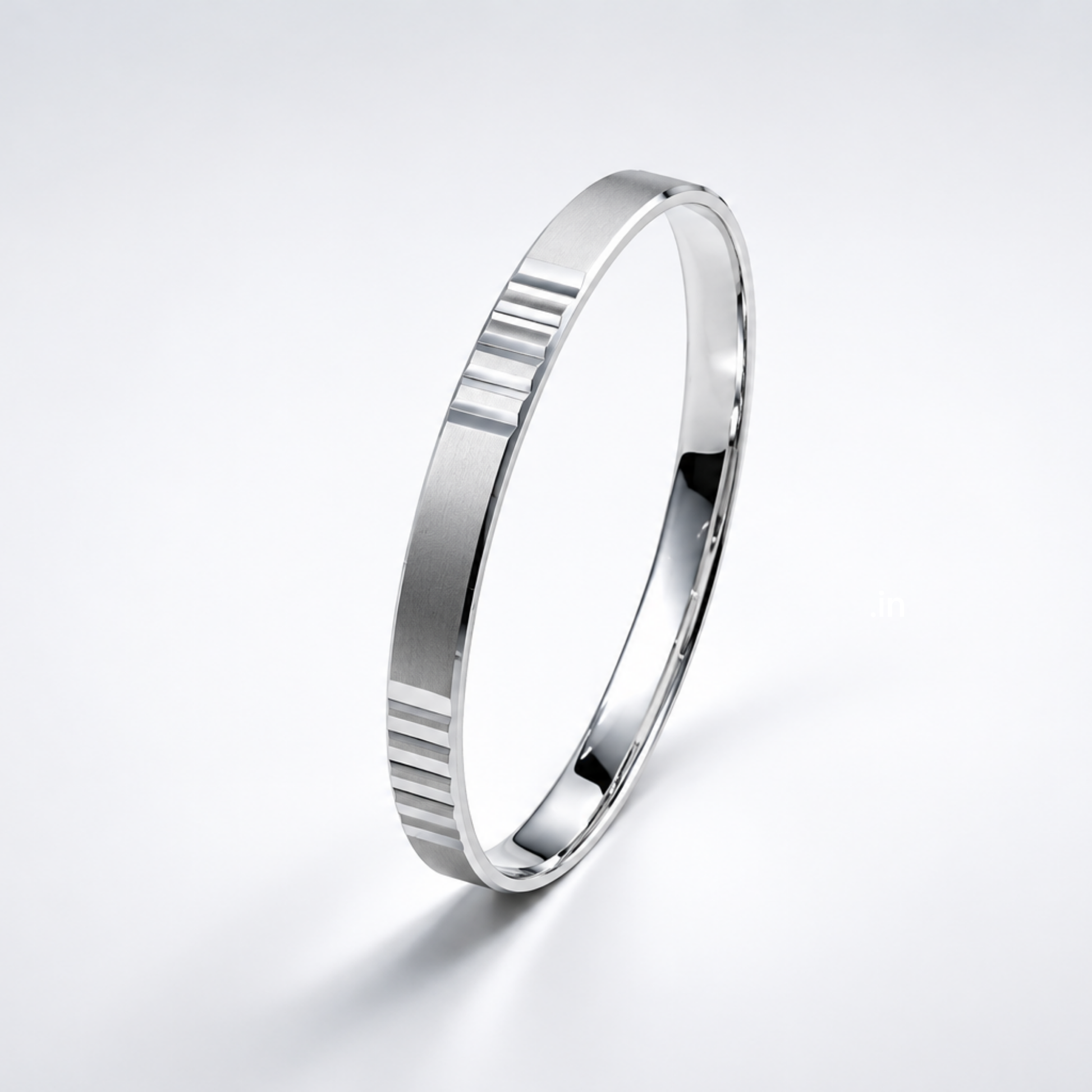 Silver ring with a ribbed design on a light gray background