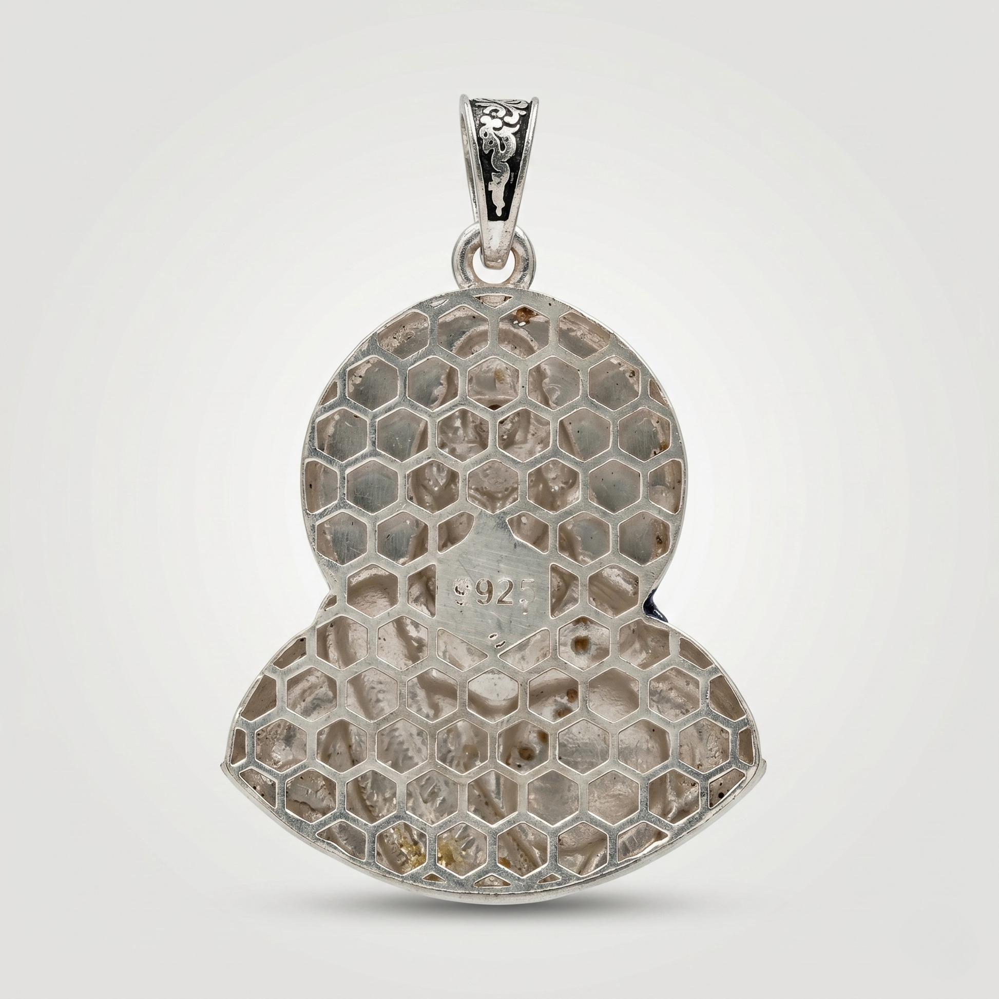 Silver honeycomb pendant on a white background